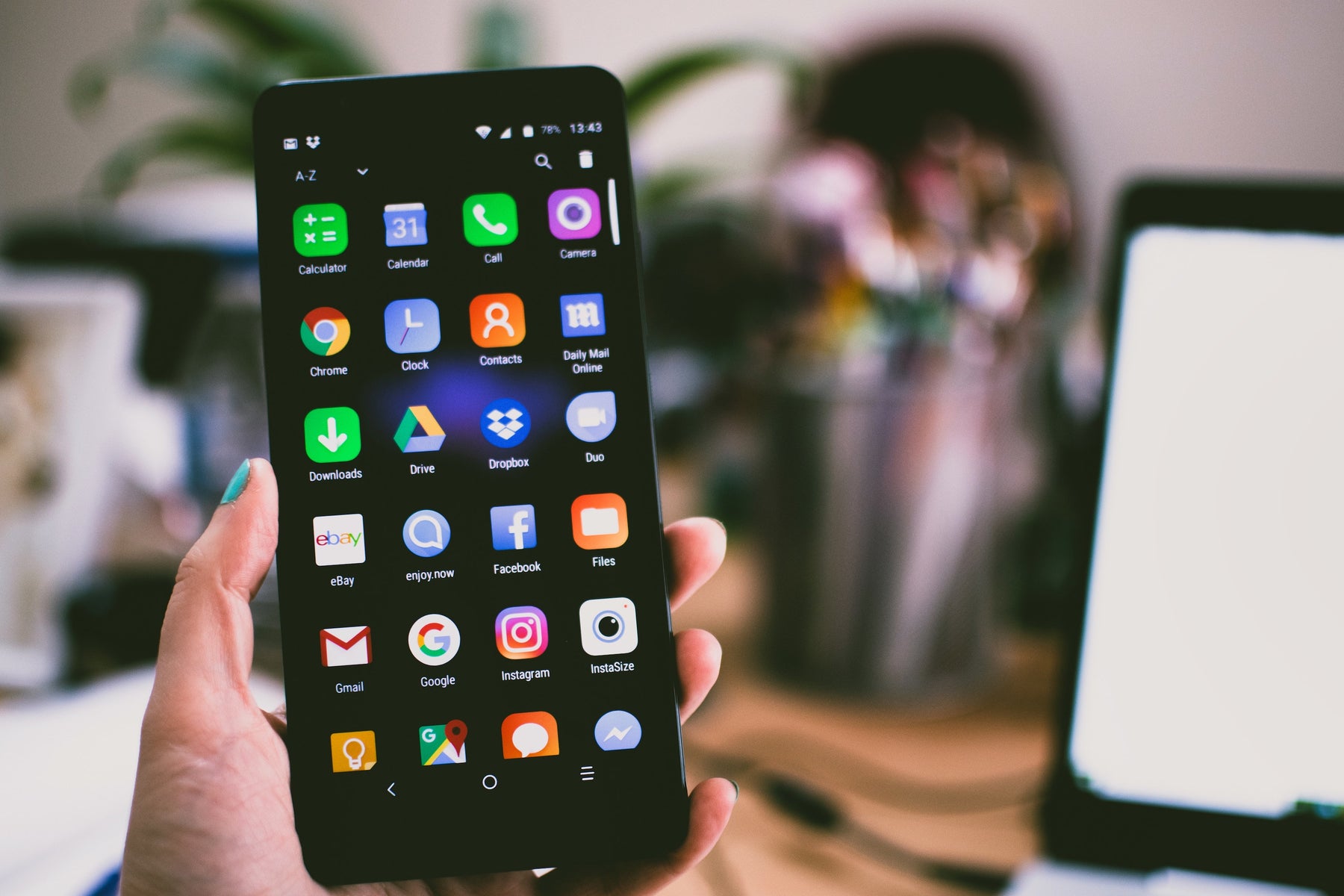 Woman holding iPhone with Instagram app visible