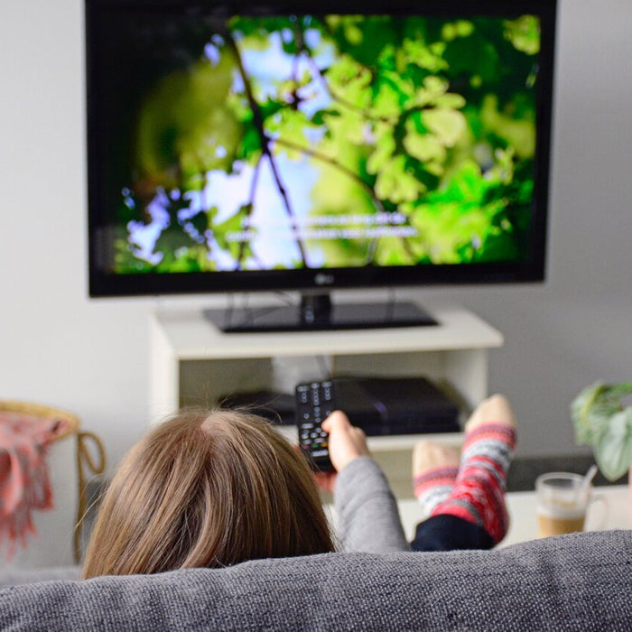 Women Watching Closed Caption On Television